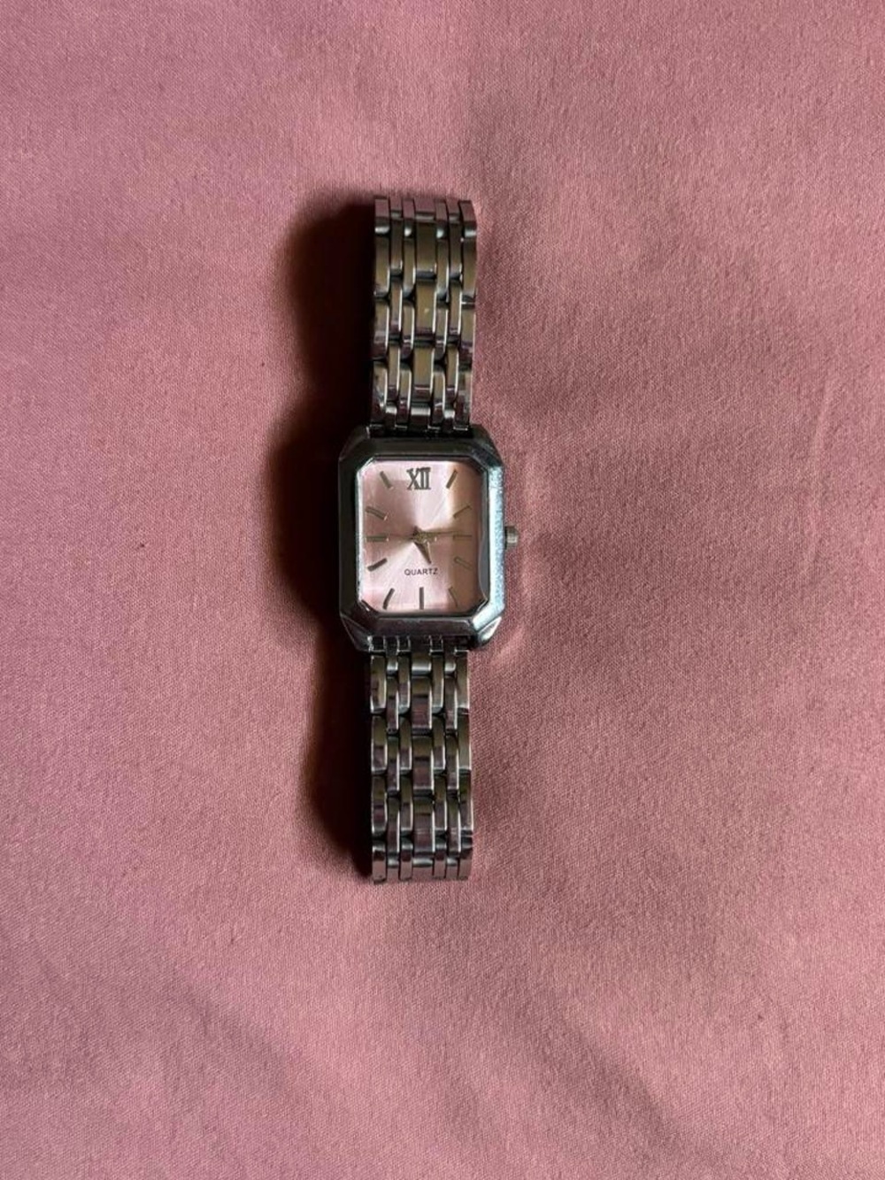 silver stainless steel women’s watch with pink quartz face